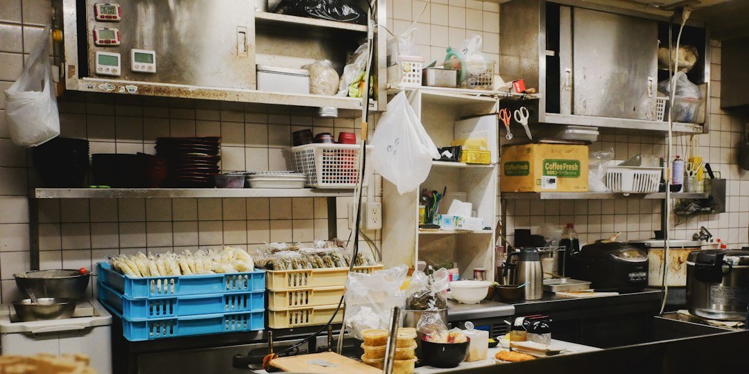 Busy kitchen counter with shelves and containers